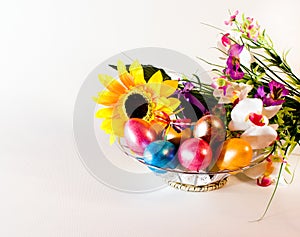 Happy easter.basket with Easter eggs and flowers.