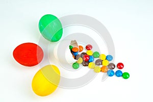 Happy Easter. Broken Easter egg with multi-colored candy decorations. on white background. Copy space for text