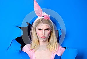 Happy easter. Bunny girl in rabbit ears looking through paper hole. Spring sale. Discount.