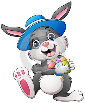 Happy easter bunny wearing a hat carrying eggs