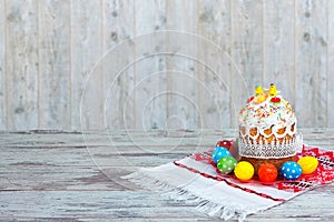 Happy Easter! Easter Cake - Russian and Ukrainian traditional kulich and colorful eggs on an embroidered towel.