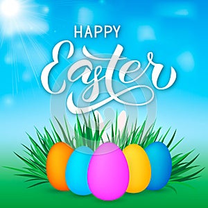 Happy Easter calligraphy lettering. Easter eggs on grass and bunny s ears. Spring holidays vector illustration. Easy to edit