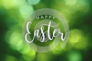 Happy Easter Calligraphy Text Over Green Spring Bokeh Background