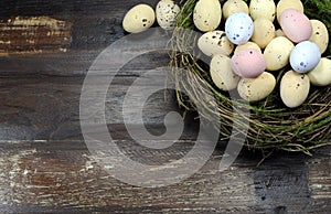 Happy Easter candy easter eggs in birds nest with copy space