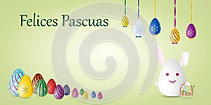 Happy Easter card in Spanish language with painted Easter eggs and rabbit.