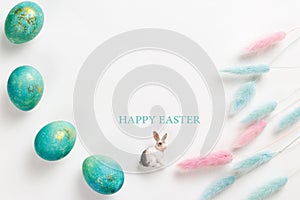 Happy easter card. Stylish minimalistic composition of turquoise with gold easter eggs on a white background. Figurine