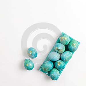 Happy easter card. Stylish minimalistic composition of turquoise with gold easter eggs on a white background. Flat lay