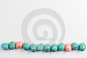 Happy easter card. Stylish minimalistic composition of turquoise with gold easter eggs on a white background. Flat lay