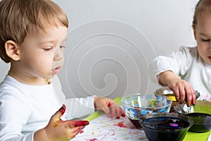 Happy easter. Children painted eggs. Two kids preparing for Easter. Painted hand. Finger paint. Art and craft concept