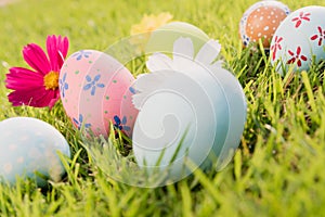 Happy easter! Closeup Colorful Easter eggs on green grass field