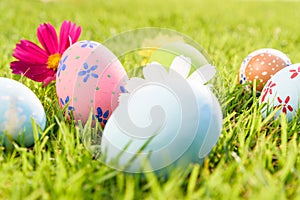 Happy easter! Closeup Colorful Easter eggs on green grass field