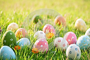 Happy easter!  Closeup Colorful Easter eggs in nest on green grass field during sunset background