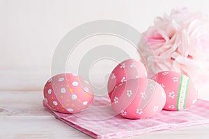 Happy easter! Colorful of Easter eggs with pink and white cheesecloth on wooden background photo