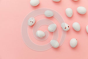 Happy Easter concept. Easter candy chocolate eggs and jellybean sweets isolated on trendy pastel pink background. Simple