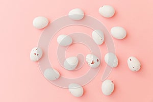 Happy Easter concept. Easter candy chocolate eggs and jellybean sweets isolated on trendy pastel pink background. Simple