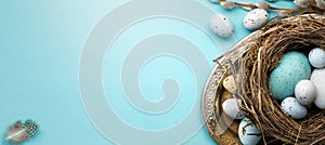 Happy Easter concept. Frame of Easter eggs and spring flowers on blue background. Flat lay, top view, copy space