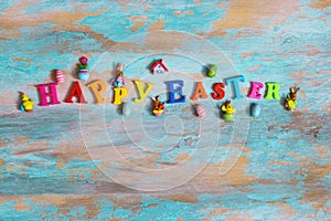 Happy Easter concept, Inscription Happy Easter letters on wooden background, top view with copy space