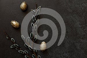 Happy Easter concept. Preparation for holiday. Golden decorated easter eggs willow on trendy grunge scratched dark black shale