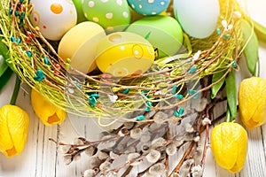 Happy Easter. Congratulatory easter background. Easter eggs and flowers. Selective focus. Top view.