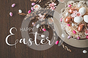 Happy Easter. Congratulatory easter background. Easter eggs on a metal plate with spring flowers on a wooden background