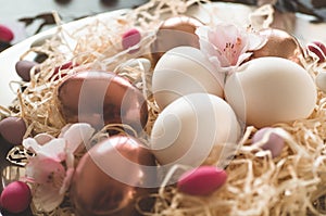 Happy Easter. Congratulatory easter background. Easter eggs on a metal plate with spring flowers on a wooden background