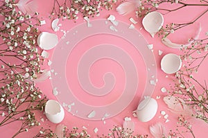 Happy Easter. Congratulatory easter background. Easter eggs with spring flowers gypsophila on a pink background