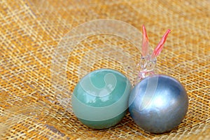 Happy Easter, Crystal rabbit with colorful eggs on bamboo weave.