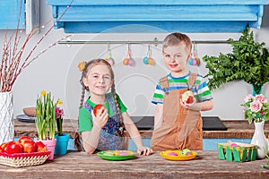 Happy easter. Cute brother and sister, funny kids boy and girl are preparing for the holiday.