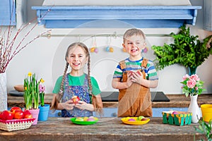 Happy easter. Cute brother and sister, funny kids boy and girl are preparing for the holiday.