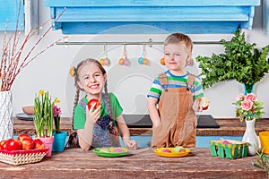 Happy easter. Cute brother and sister, funny kids boy and girl are preparing for the holiday.