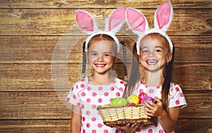Happy easter! cute twins girls sisters dressed as rabbits with e