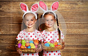 Happy easter! cute twins girls sisters dressed as rabbits with e