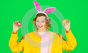 Happy Easter day. Smiling Woman in bunny ears with colored eggs. Egg hunt. Rabbit girl.