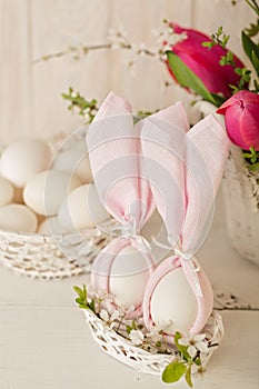 Happy easter. Decor of Easter eggs in small white baskets.