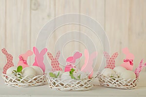 Happy easter. Decor of Easter eggs in small white baskets.