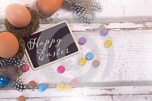 Happy easter decoration with blackboard and eggs