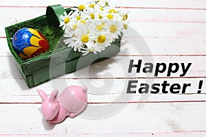 Happy easter decoration with flowers and a easteregg