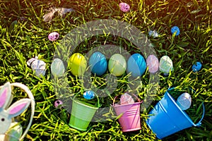 Happy Easter. Easter eggs in a row hidden in spring grass