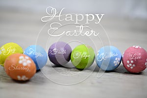 Happy Easter. Easter eggs on a white wooden background. Bright colorful Easter egg with kind and positive single word on it