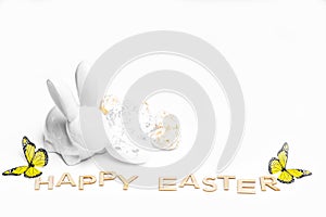 Happy Easter. Easter white bunny on a white background with Easter eggs.Easter greeting card with easter bunny