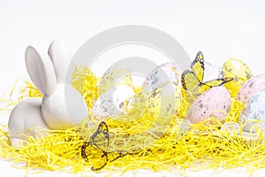 Happy Easter. Easter white bunny on a white background with Easter eggs.Easter greeting card with easter bunny