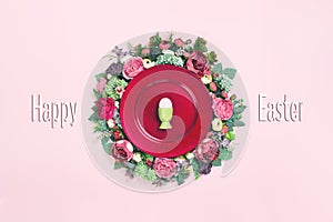 Happy Easter egg plate on floral wreath flat lay