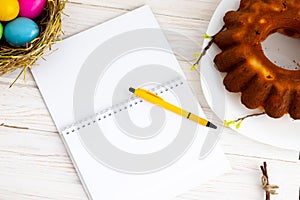 happy Easter easter eggs, cupcake. place for text in the form of a notepad and pen