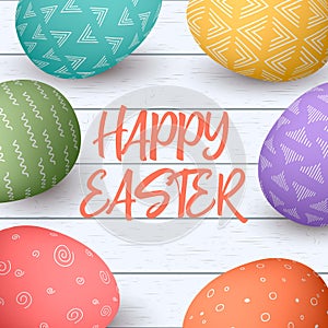 Happy Easter eggs frame with text. Colorful easter eggs on white wooden background.