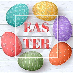 Happy Easter eggs frame with text. Colorful easter eggs on white wooden background. Your design,