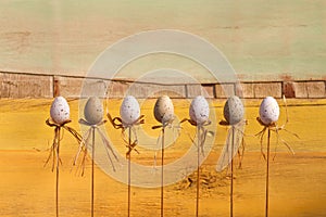 Happy Easter Eggs on Sticks Yellow Background