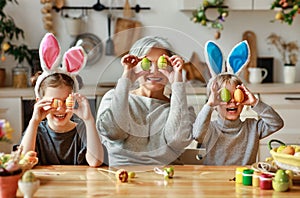 Happy easter! family   grandmother and children grandchildren paint eggs for holiday