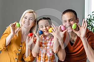 Happy easter! family mother, father and children having fun paint and decorate eggs for holiday