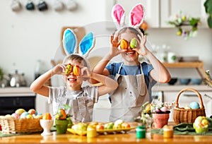 Happy easter! funny children   with ears hare playing and getting ready for  holiday