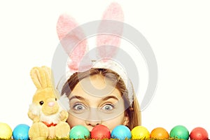 Happy easter girl in bunny ears with colorful eggs, rabbit